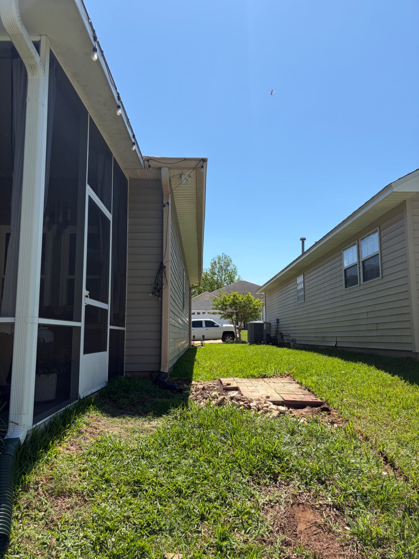 Before photo of the backyard side yard before patio construction.